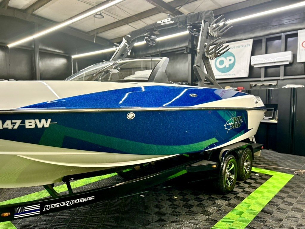 Metallic blue Axis wake boat on its trailer, ceramic coated at Elite Auto Spa in San Tan Valley