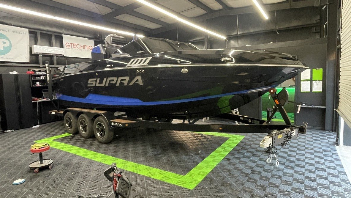 Freshly ceramic coated black Supra wake boat in the shop at Elite Auto Spa