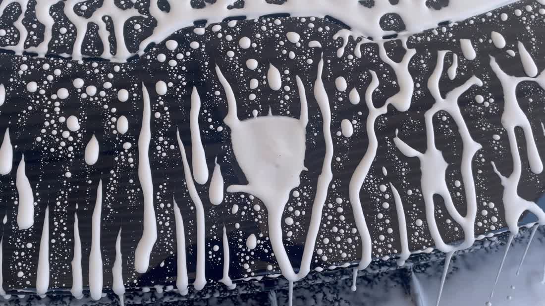 Snow foam running off a ceramic coated black panel
