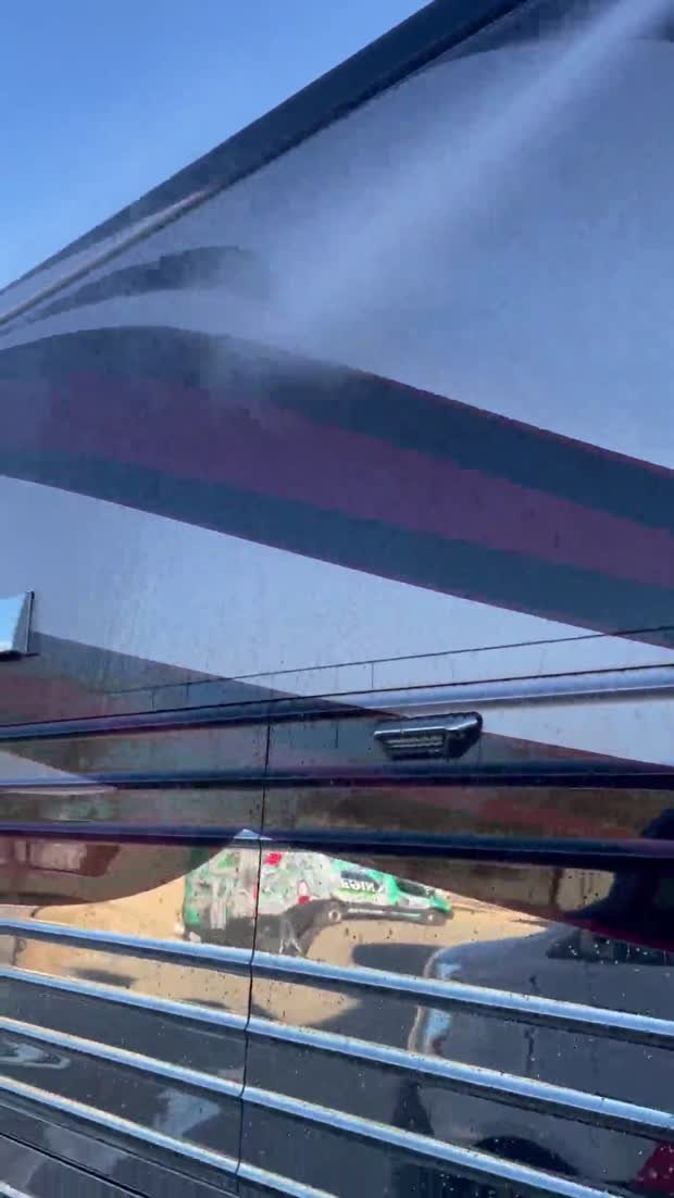 Water rinsing down the side of a ceramic coated motorcoach